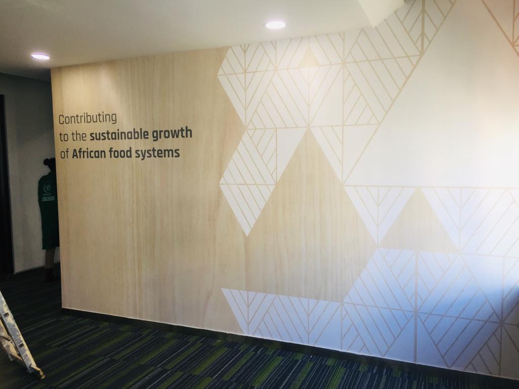 Geometric corporate wall mural with text. 